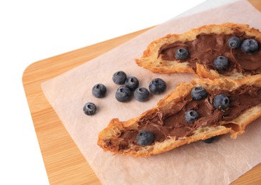 Photo of Tasty croissant with chocolate paste and blueberries on white background