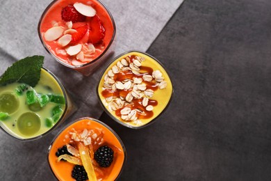 Photo of Many different delicious smoothies on grey table, flat lay. Space for text