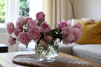 Beautiful pink peonies in vase on table at home. Interior design