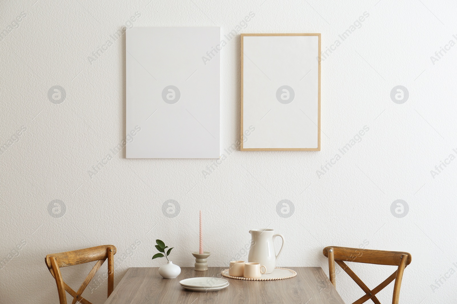 Photo of Room interior with wooden chairs, dining table and posters