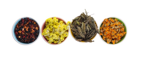 Photo of Many different dry herbs and flowers in bowls isolated on white, top view