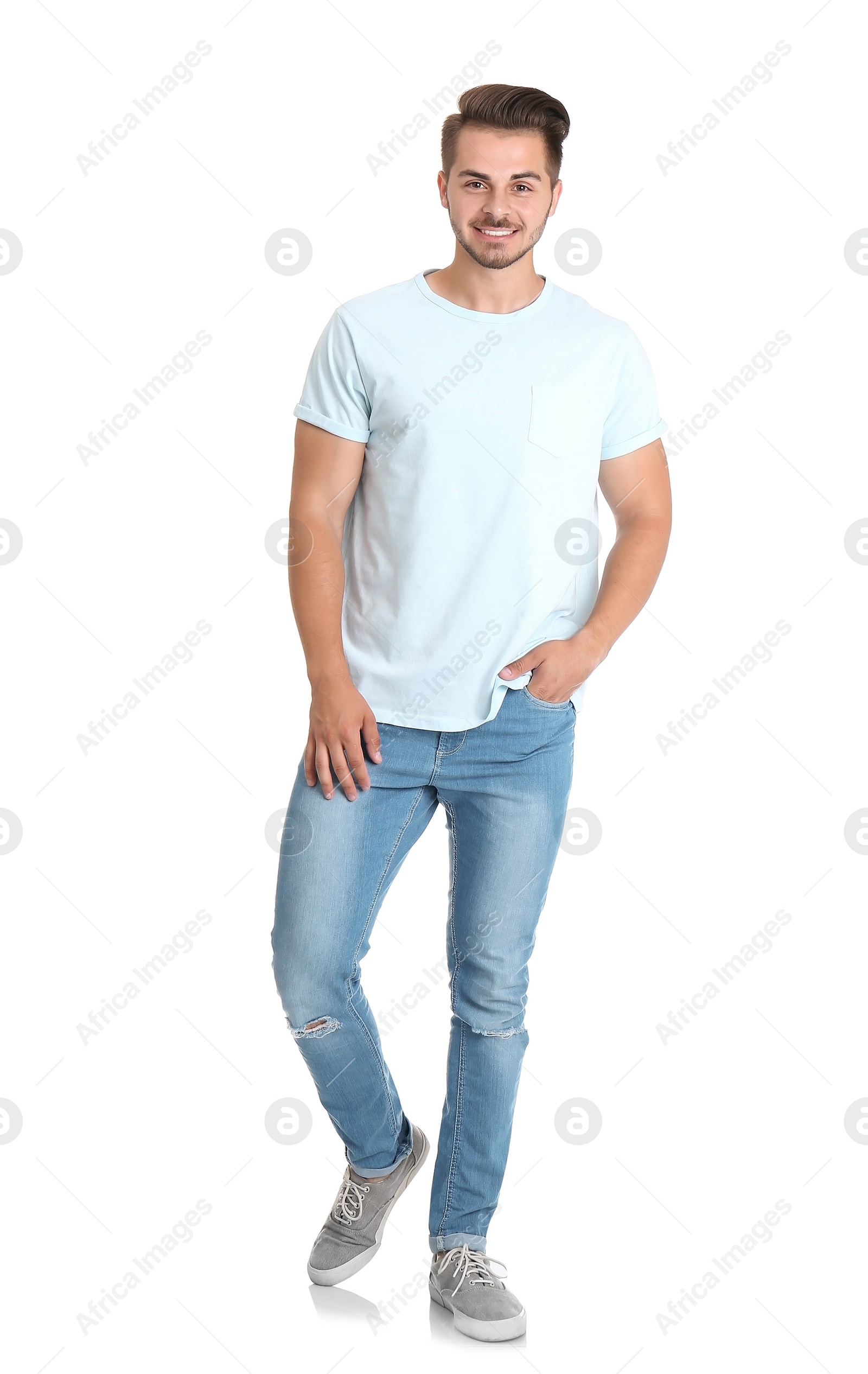 Photo of Young man in stylish jeans on white background