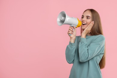 Photo of Special promotion. Young woman shouting in megaphone on pink background, space for text
