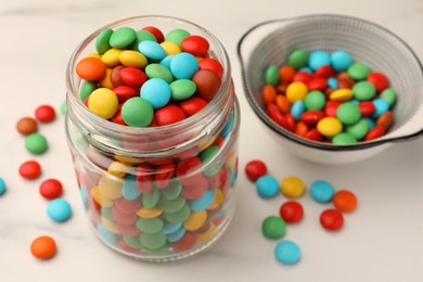 Photo of Tasty colorful candies on white table, closeup