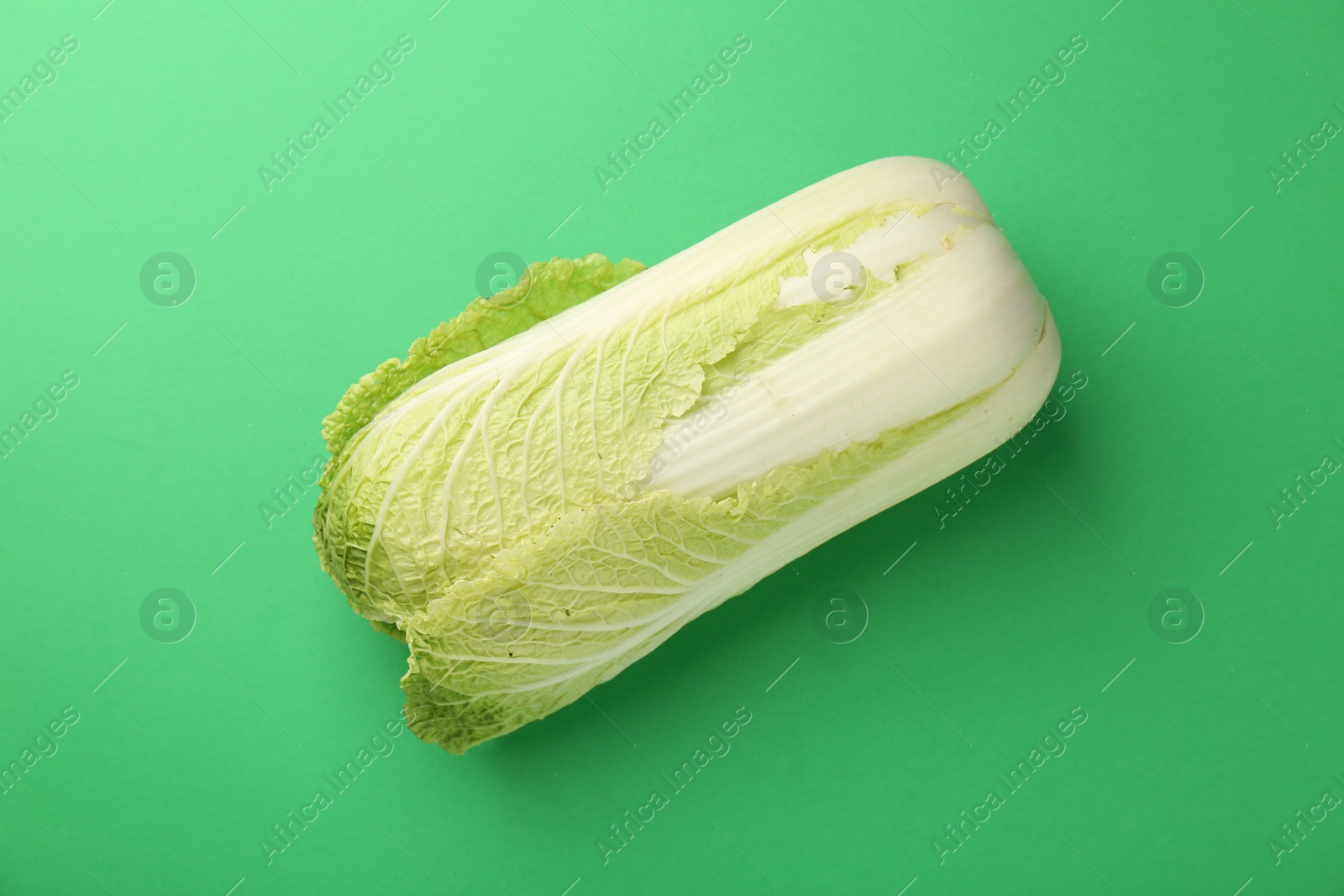 Photo of Fresh ripe Chinese cabbage on green background, top view