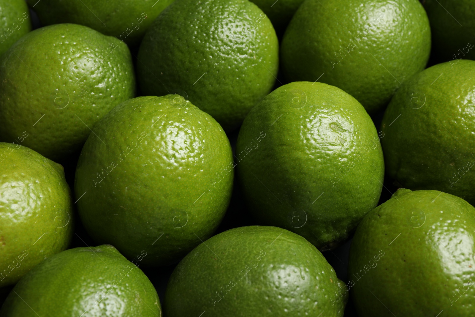 Photo of Fresh ripe green limes as background, closeup