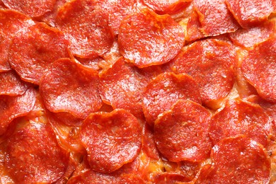 Tasty pepperoni pizza as background, top view