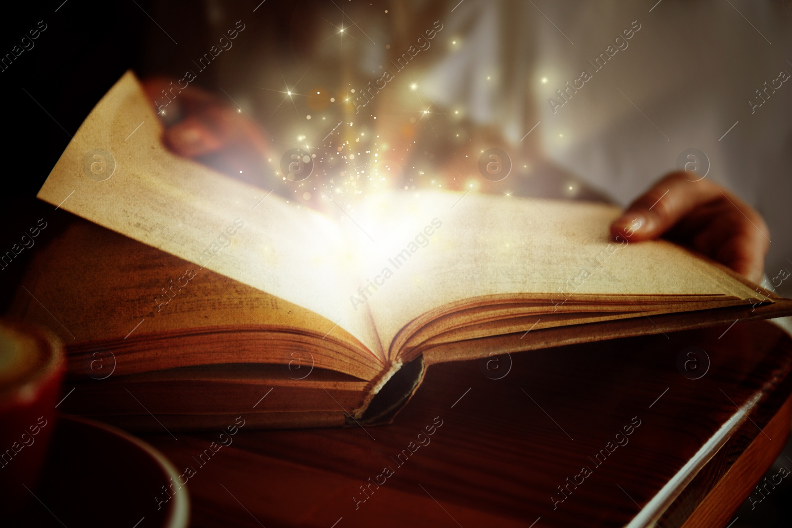 Image of Woman reading shiny magic book, closeup view