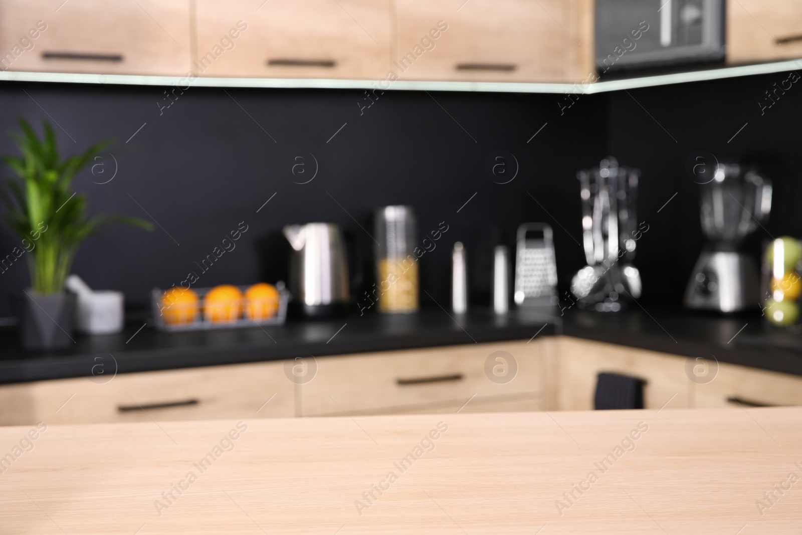 Photo of Countertop and blurred view of kitchen interior on background