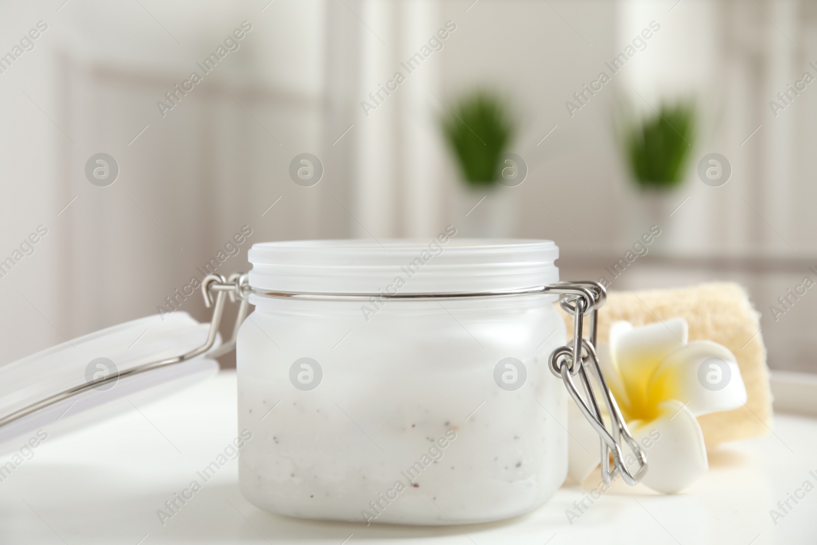 Photo of Salt scrub and plumeria on white table