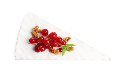 Photo of Brie cheese served with red currants and walnuts isolated on white, top view