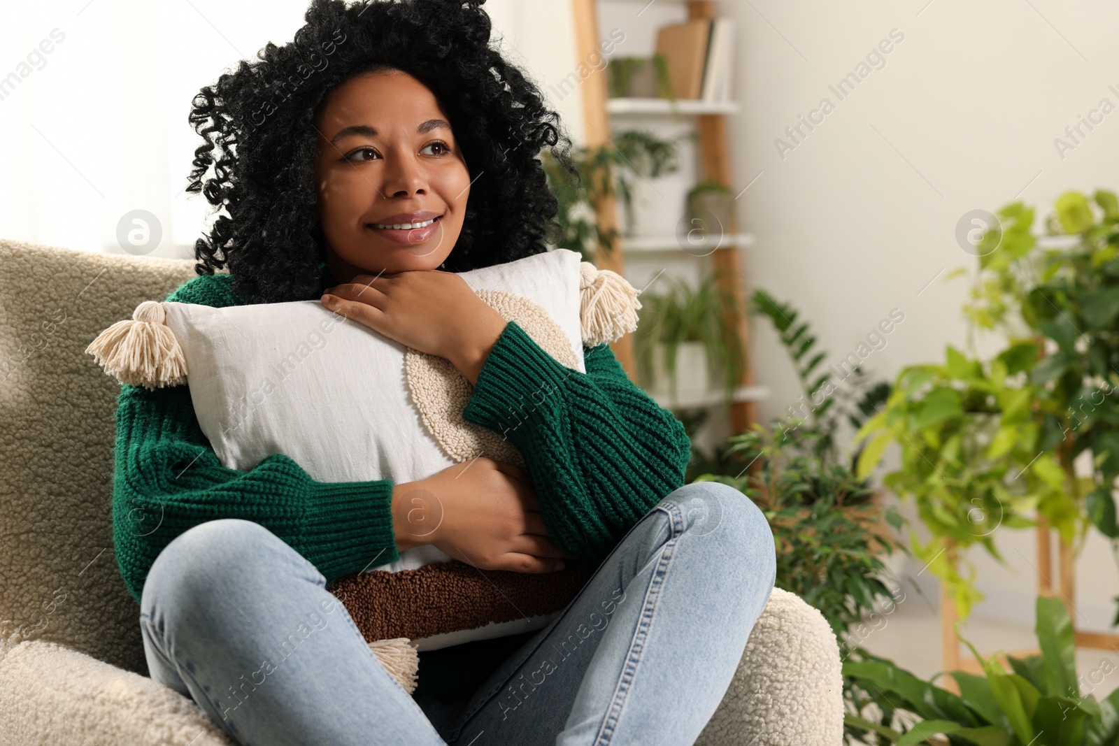 Photo of Happy woman relaxing near beautiful houseplants at home. Space for text