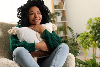 Photo of Happy woman relaxing near beautiful houseplants at home. Space for text