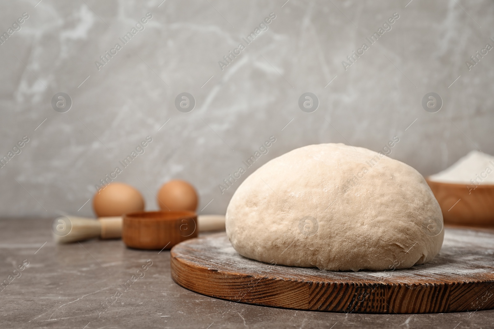 Photo of Fresh raw dough ball on wooden board