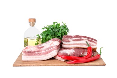 Photo of Pieces of raw pork belly, parsley, chili peppers and oil isolated on white