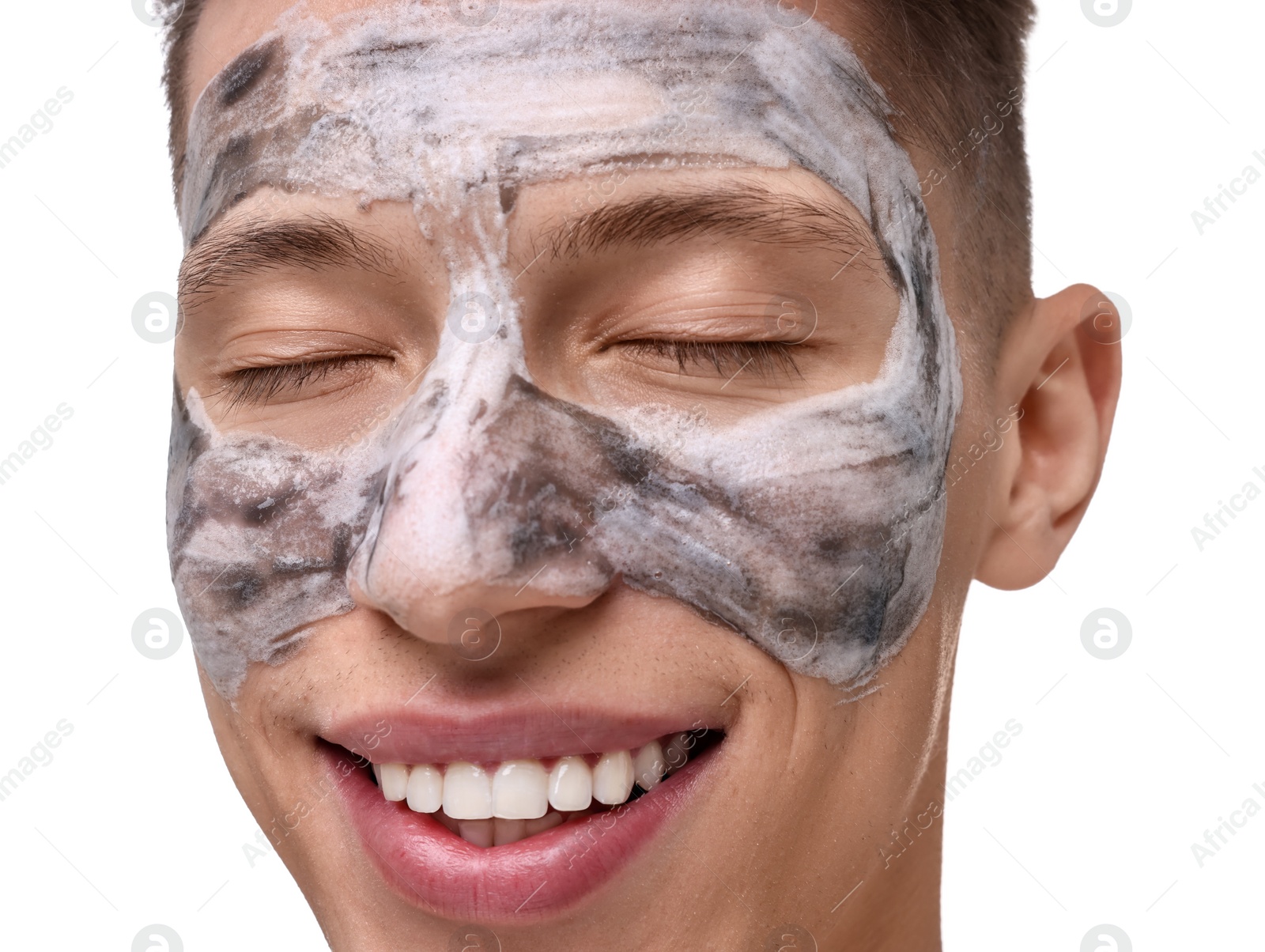 Photo of Handsome man with clay mask on his face against white background, closeup