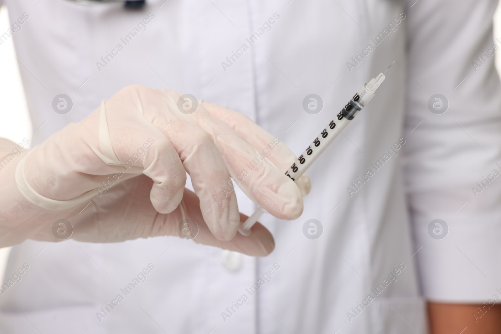 Photo of Doctor holding medical syringe with needle, closeup view