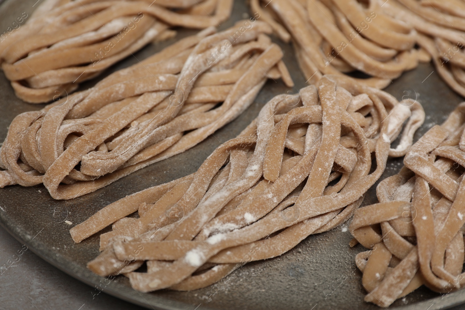 Photo of Uncooked homemade soba on tray, closeup view