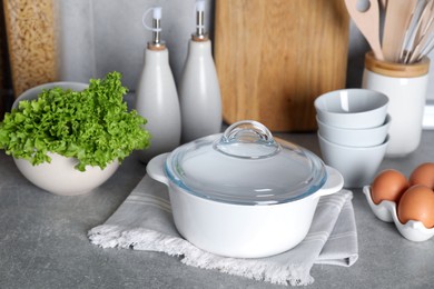 Set of different cooking utensils and products on grey countertop in kitchen