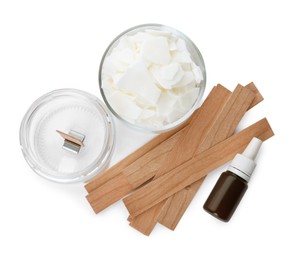 Photo of Wax flakes, essential oil and wooden wicks on white background, top view. Making homemade candle
