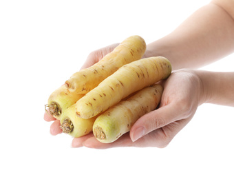 Photo of Woman holding raw carrots on white background, closeup