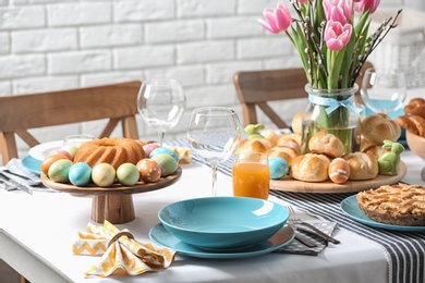 Photo of Festive Easter table setting with traditional meal at home