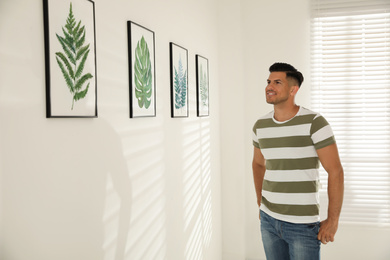 Happy man at exhibition in art gallery