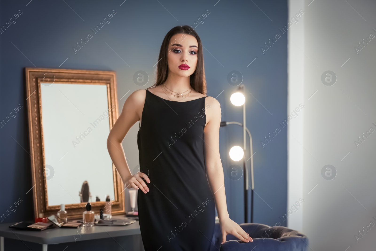 Photo of Portrait of beautiful woman with bright makeup indoors