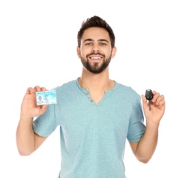 Happy young man with driving license and car key on white background