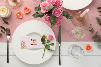 Romantic table setting with flowers and candles, flat lay