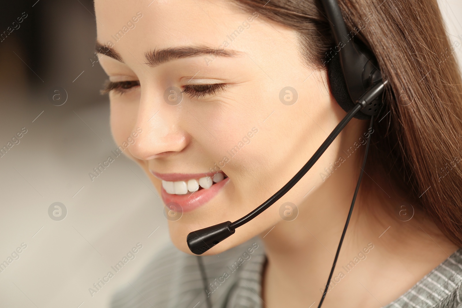 Photo of Hotline operator with headset working in office, closeup