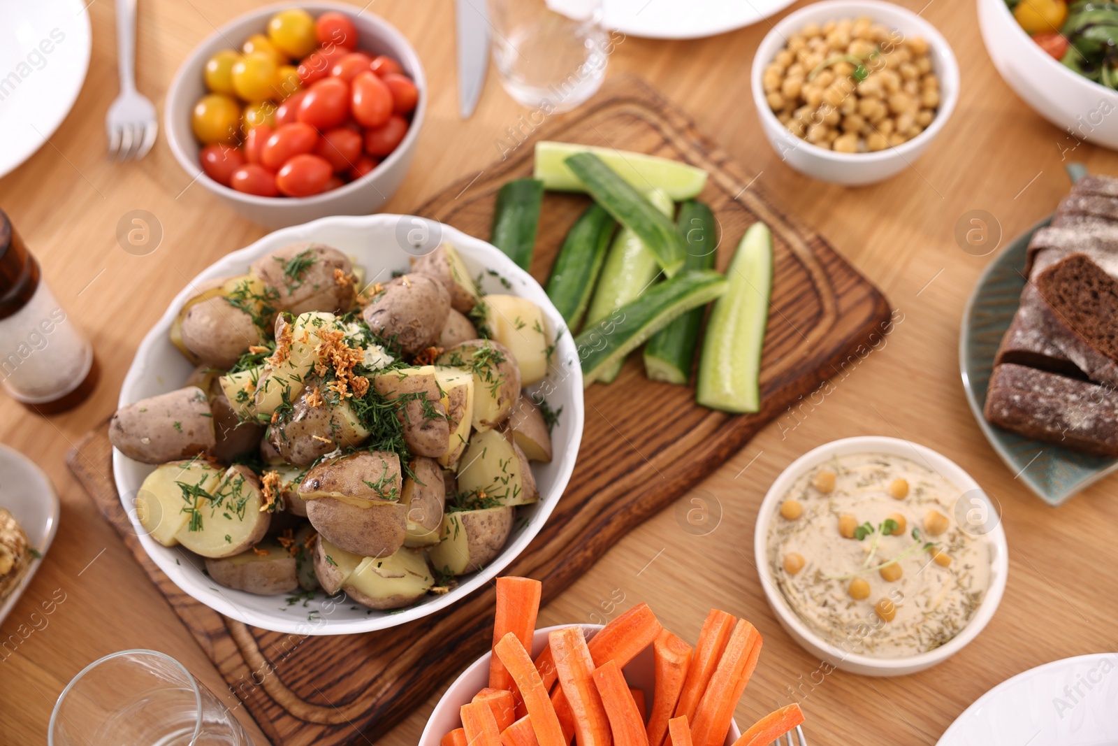 Photo of Healthy vegetarian food on wooden table, above view