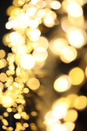 Photo of Golden blurred lights on black background. Bokeh effect