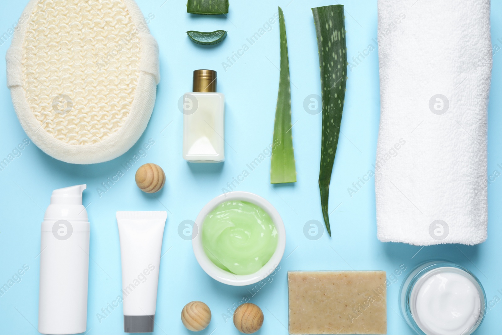 Photo of Flat lay composition with aloe vera and cosmetic products on light blue background