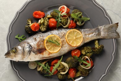 Photo of Baked fish with vegetables, rosemary and lemon on grey textured table, top view