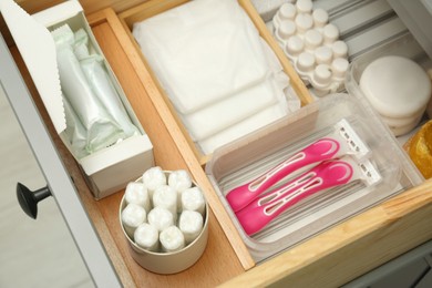 Photo of Storage of different feminine hygiene products in drawer, above view