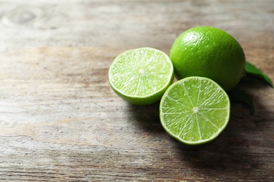 Fresh ripe green limes on wooden background