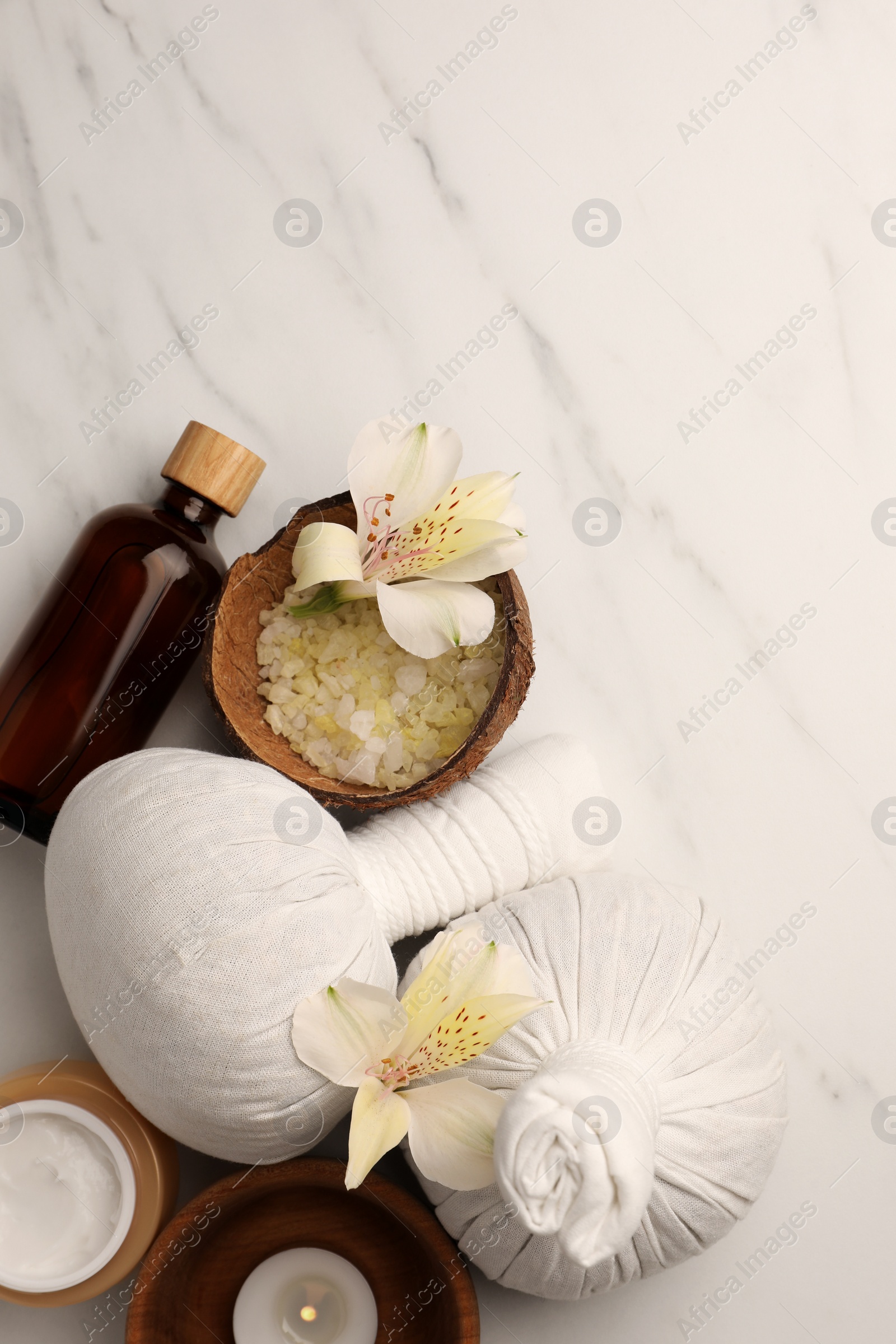 Photo of Flat lay composition with spa products and flowers on white marble table. Space for text