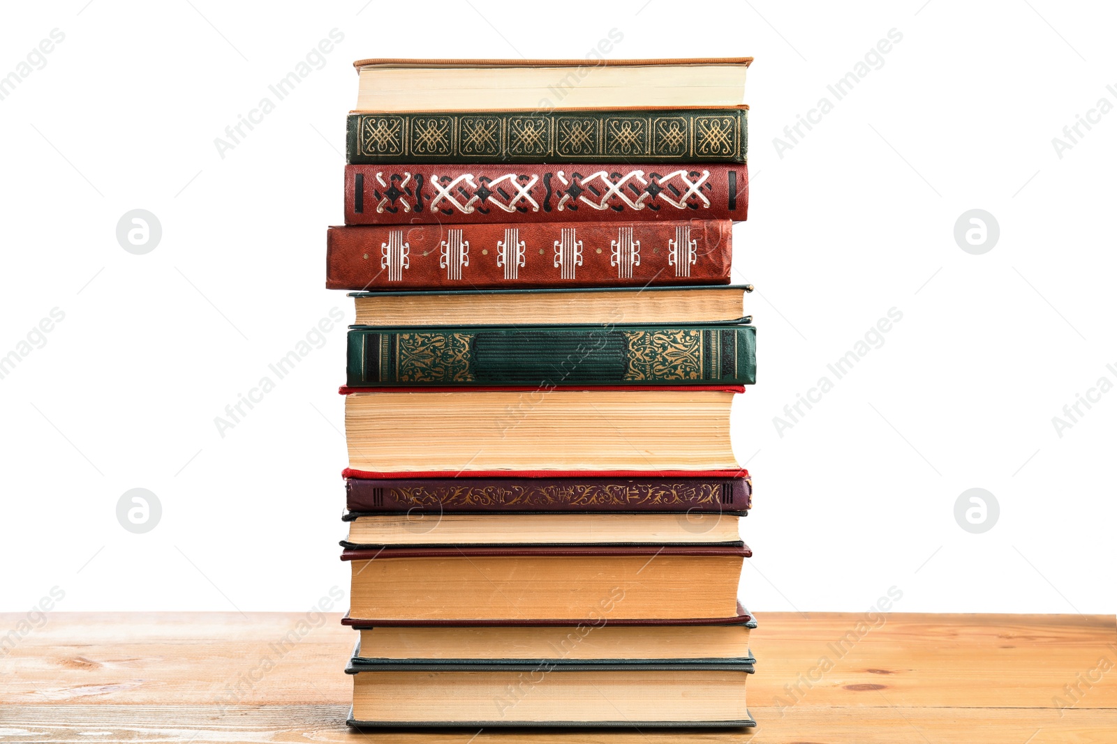 Photo of Stack of old vintage books on wooden table against white background