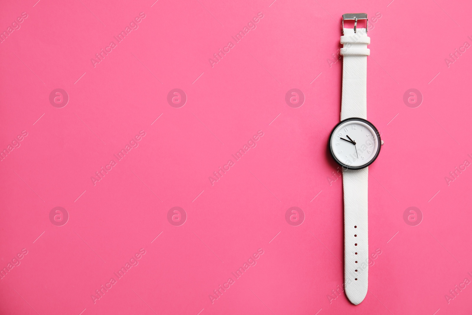 Photo of Stylish wrist watch on color background, top view with space for text. Fashion accessory