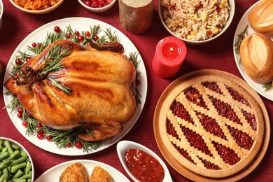 Photo of Traditional festive dinner with delicious roasted turkey served on table, flat lay