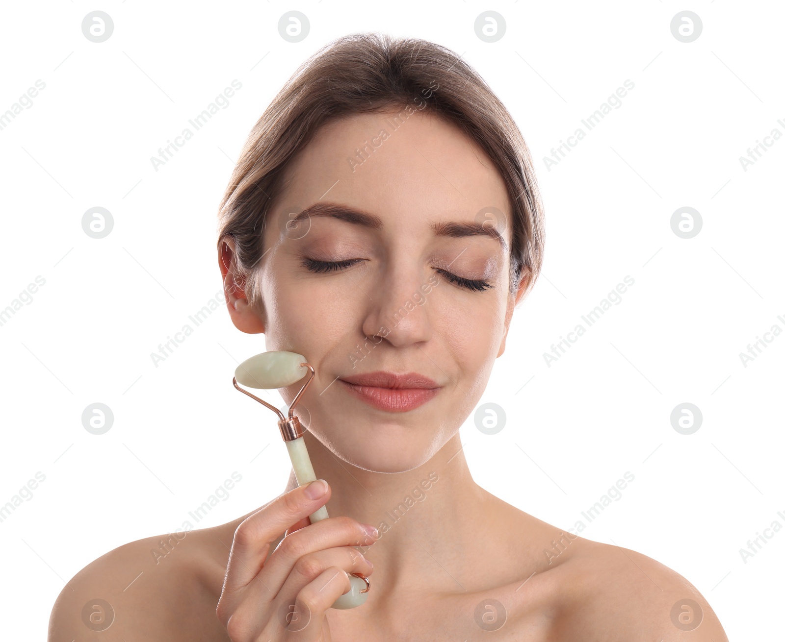 Photo of Young woman using natural jade face roller on white background