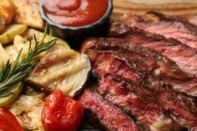 Delicious grilled beef steak with vegetables and spices on table, closeup