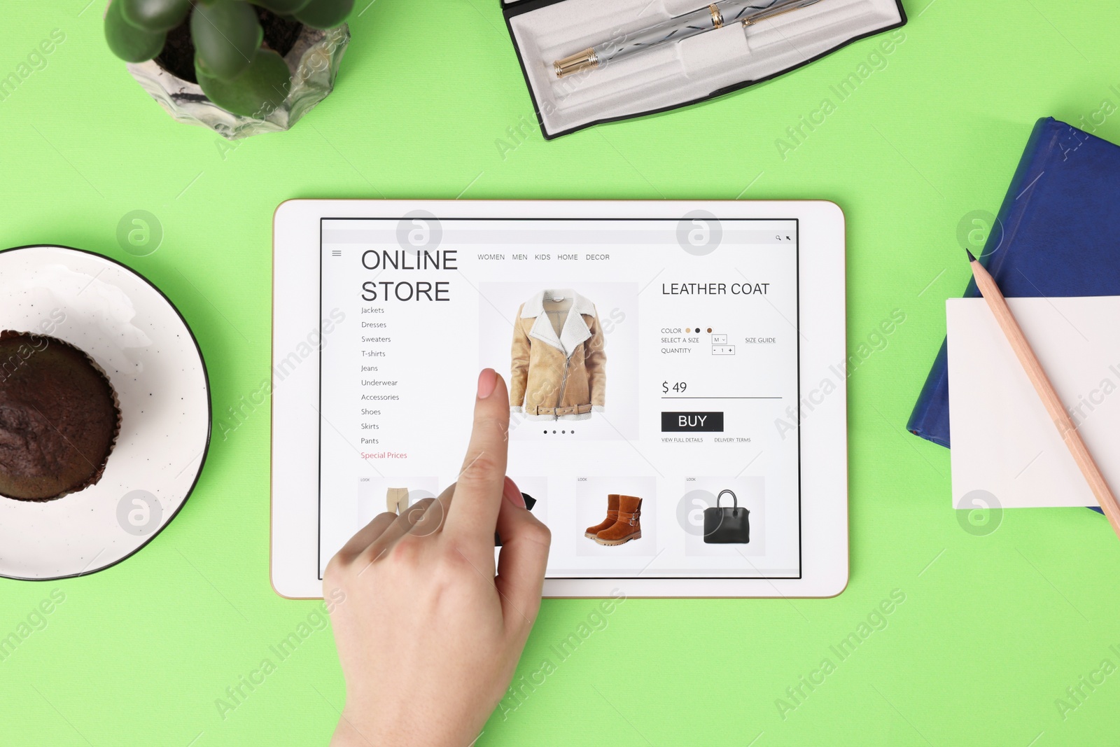 Photo of Woman with tablet shopping online on green background, top view