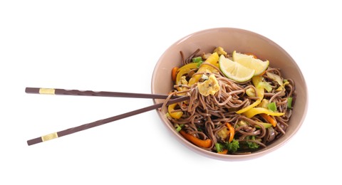 Photo of Stir-fry. Delicious cooked noodles with chicken in bowl and chopsticks isolated on white, top view