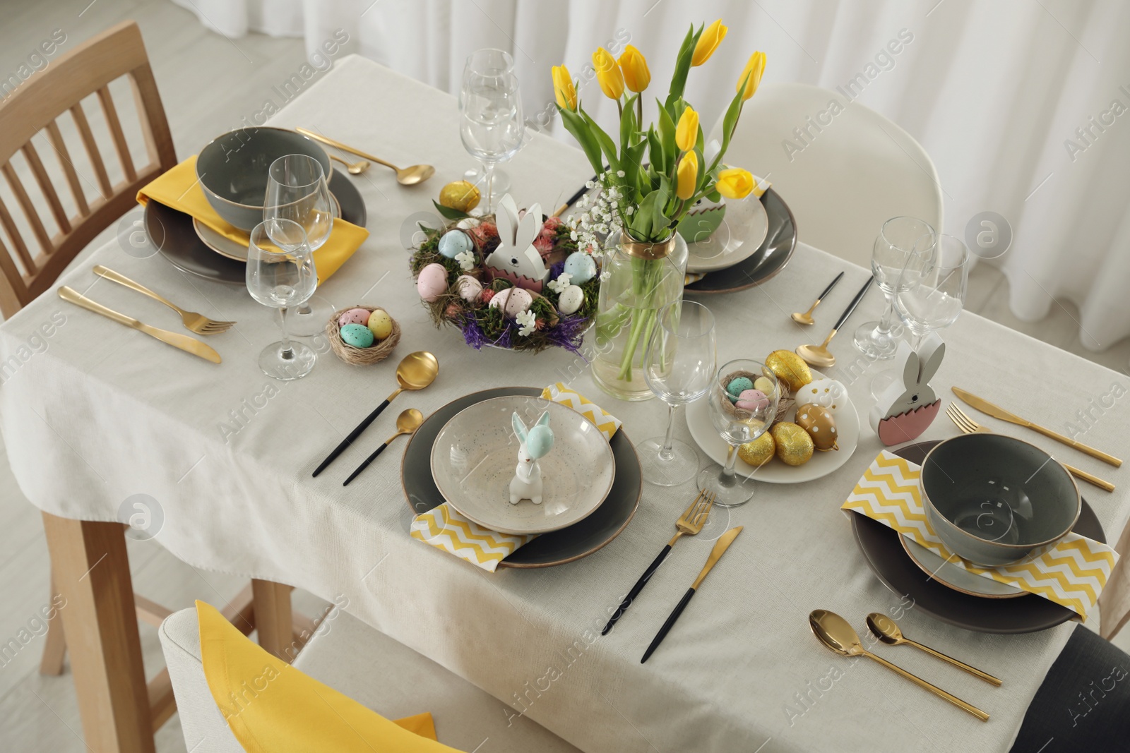 Photo of Beautiful Easter table setting with festive decor indoors