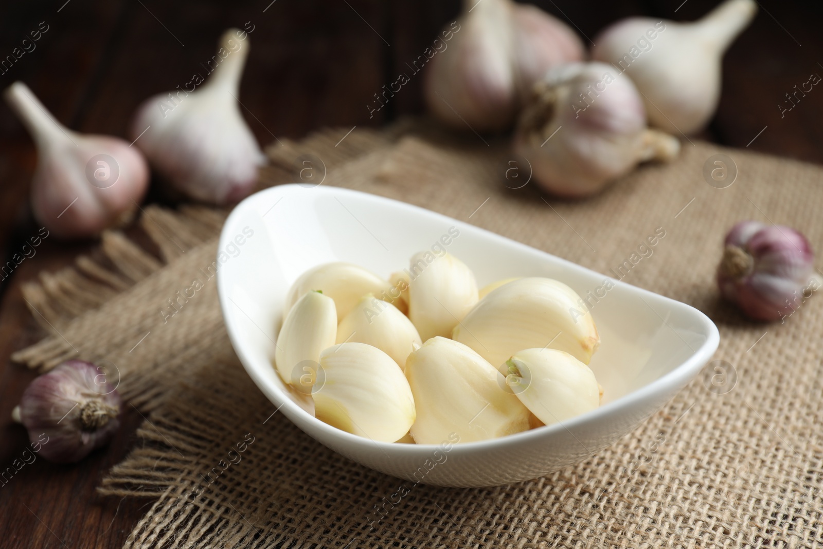 Photo of Fresh garlic cloves and bulbs on table, closeup