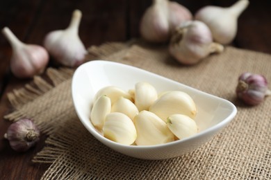 Photo of Fresh garlic cloves and bulbs on table, closeup