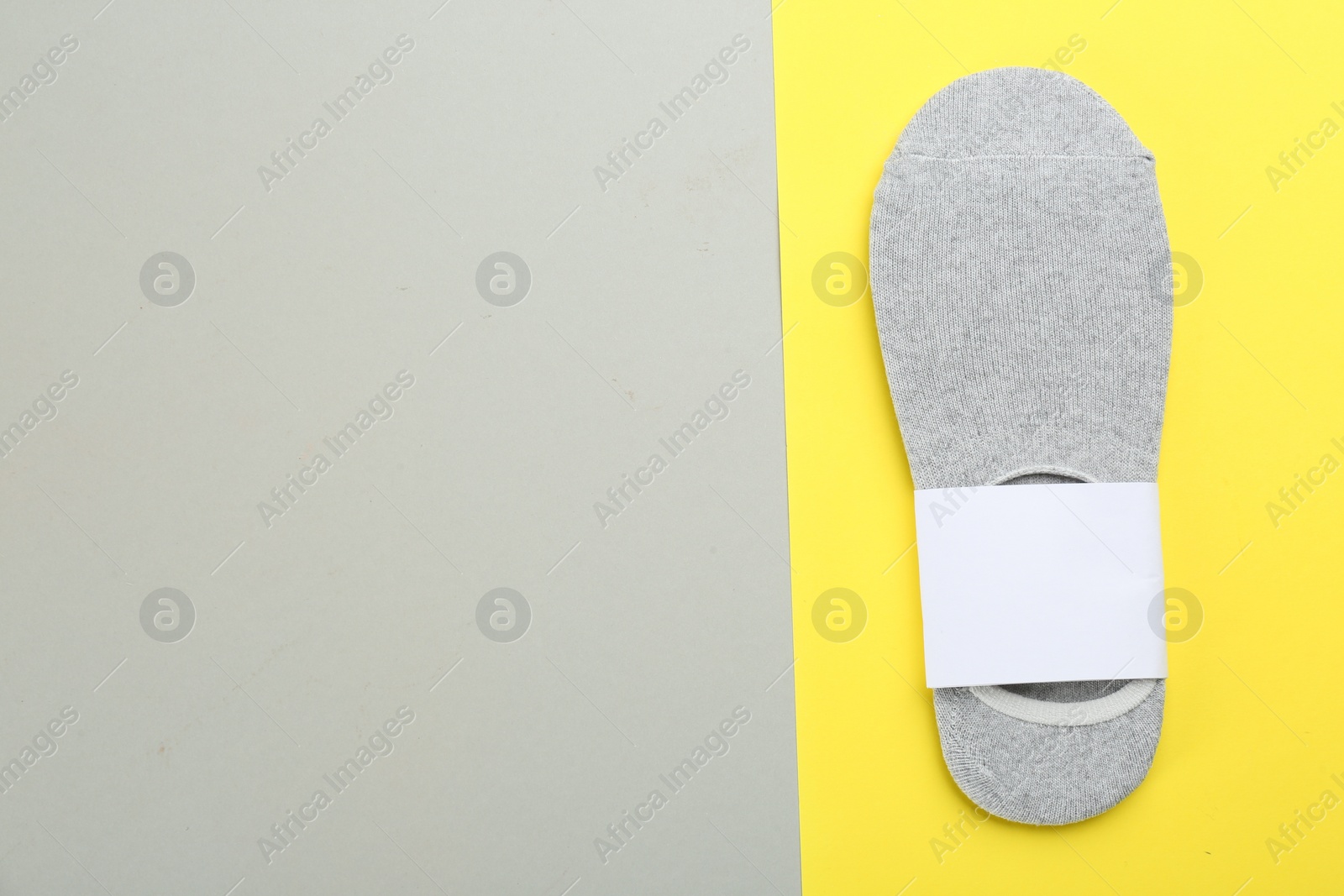 Photo of Pair of cotton socks on color background, top view. Space for text