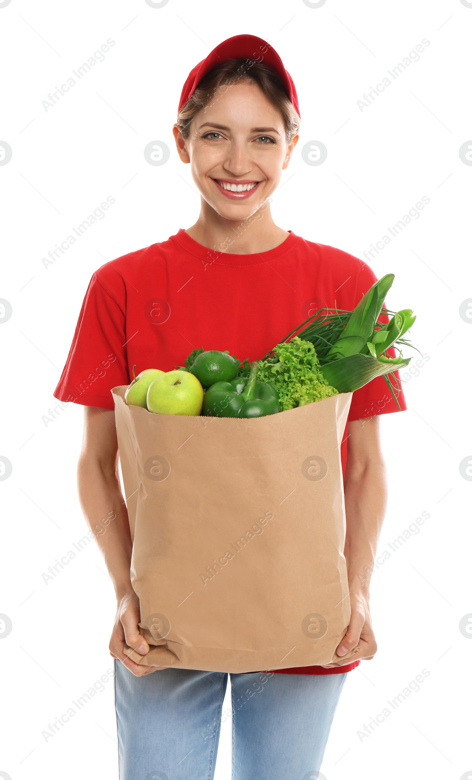 Photo of Delivery woman with bag of fresh vegetables on white background